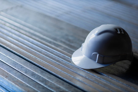 White safety helmet on metal surface construction concept