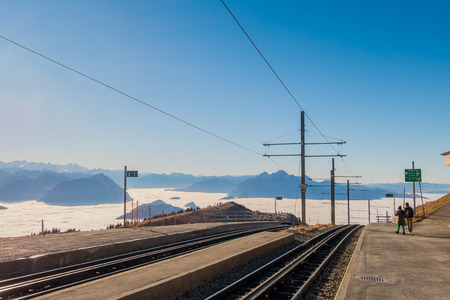 Utility poles and power lines supply electricity to cogwheel trains climbing Mount Rigi in Switzerland.の写真素材