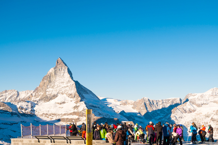 Zermatt, SWITZERLAND - DECEMBER 26, 2016: Skiers and snowboarder were leaving the train prepare to ski at Gornergrat train station with matterhorn peak view at the background of ski track.のeditorial素材