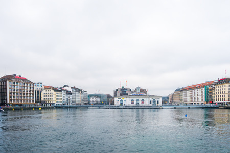 Geneva, Switzerland - December 24, 2016: Riverside buildings with offices of famous brands near Rhone river in city center of Geneva . It is a  a financial center and worldwide center for diplomacyのeditorial素材
