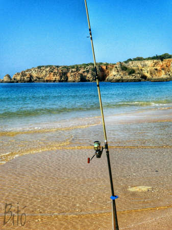 A moment to relax. Fishing in seashore... with the clifs in the background.の素材