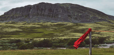 Red raincoat flying in the wind