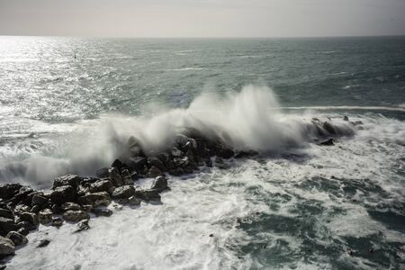 Wave hitting a waterblock in Italy - Riomaggioreの写真素材