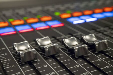 Audio Mixer with Faders pushed up on a Mixer