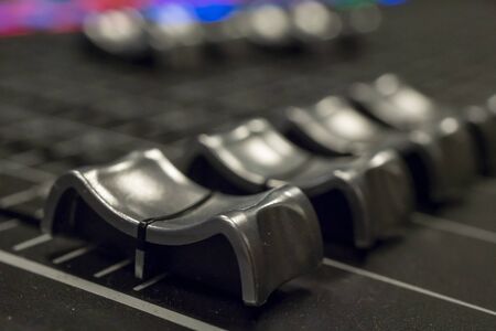 Audio Mixer with Faders pushed up on a Mixer