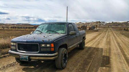 Muddy Pickup Truck On DirtRoadの写真素材