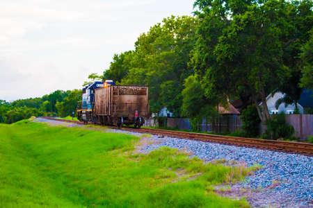 A train passing by a neightborhood.の写真素材