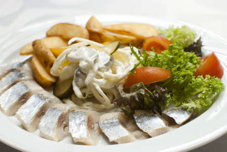 Fish with potatoes and vegetablesの写真素材