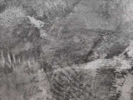 The background is a shiny cement floor with cracks.の写真素材