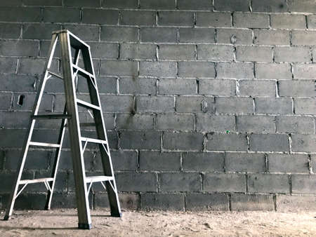 White steel, which is located on the floor and has a cement wall background.の写真素材