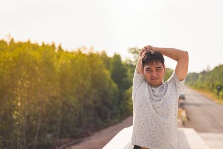 Man stretching body before running at the park and sunset timeの写真素材
