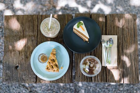 Coffee and cake, afternoon on a wooden table in the garden, top viewの写真素材