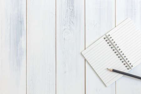 Notebook and pencil on wooden table, Top view, Concept of workplace, equipment, illustration, office supplies, backgroundの写真素材