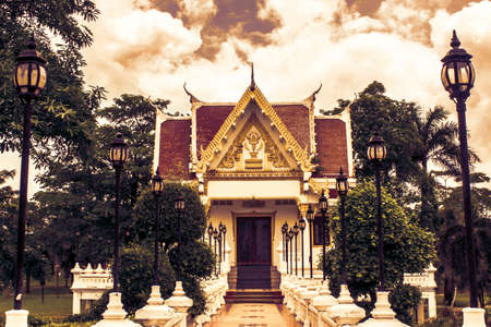 Thai temple and cloudy sky in sun shineの写真素材
