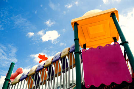 Playground in bright blue skies and white clouds in morningの写真素材