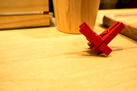 The clothespin-like heart set on a wooden table in kitchenの写真素材