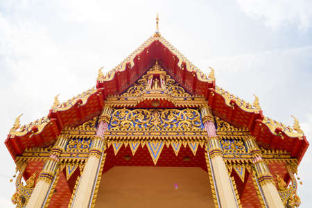 Thailand Temple in front of a cloudy sky in sun shine morningの写真素材