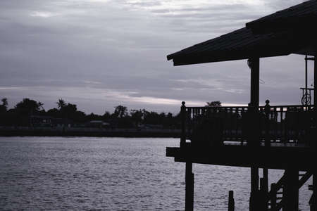 Waterfront home in the evening by the river in thailand nightの写真素材