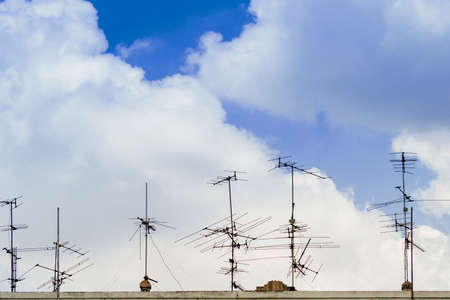 TV antenna on the roof of the sky with cloudsの写真素材
