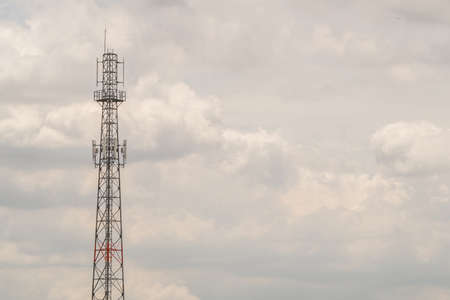 Communication towers in the sky dark at the half in afternoon time