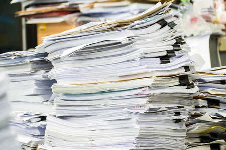 Stack of paper in the office and more work