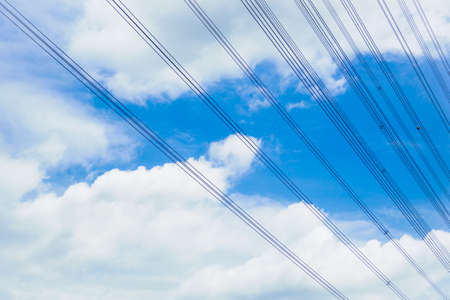A power line on the blue sky in sun light.の写真素材