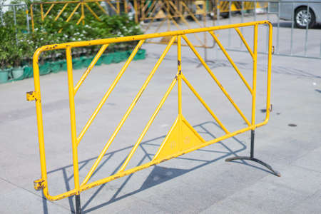 Yellow fence in the parking lot in sun light.