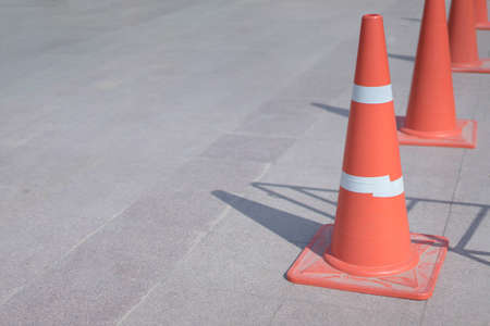 Orange cones in the parking lot at noon in market place.の写真素材