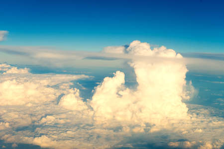 Mostly cloudy, with a view from the plane in sunshine.