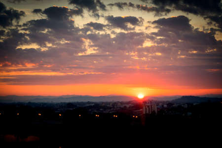 Black morning sky with clouds in sunshine.の写真素材