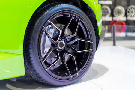 Wheel drive with green car on a white floor in Garage.の写真素材