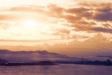Sun shining over river in morning time.の写真素材