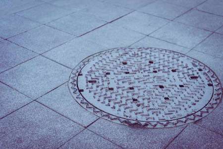 Drain them on the way in the big city at noon.の写真素材