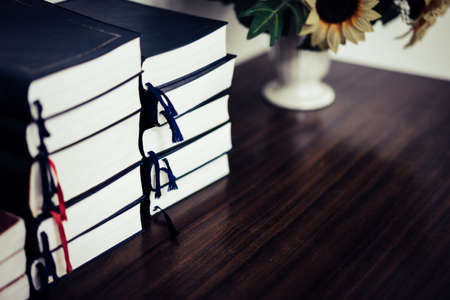 Stack of books on the table in the library in relax time.の写真素材