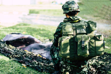 Military observer seats on the grass in war.の写真素材