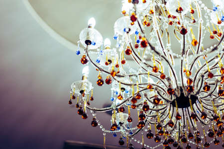 Chandelier in a dark room, vintage tone in soft light.の写真素材