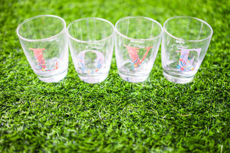 Glass wrote love side lay on the grass at morning time.の写真素材