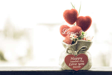 Heart-shaped Valentine's Day gifts in a sack in soft light.の写真素材