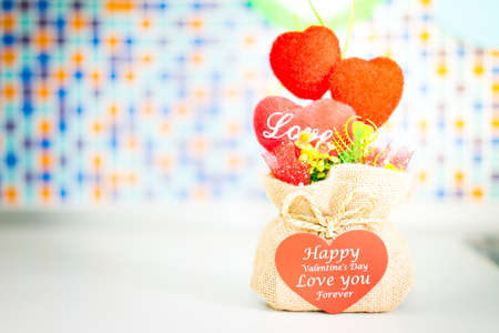 Valentine's Day heart-shaped gift in a bag on the table in kitchen.の写真素材