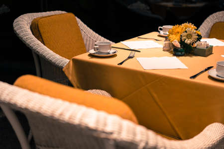 Dining table laid bare in the elegant restaurant in warm tone.の写真素材