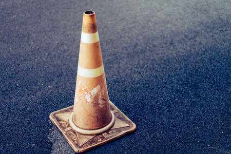 Orange traffic cones placed on historic ground in morning rain.の写真素材
