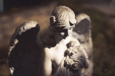 Statue of a winged angel in the dark vintage tone.の写真素材
