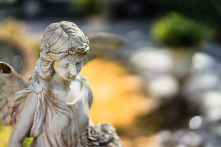 Winged angel statue in the park in the sunshine day.の写真素材