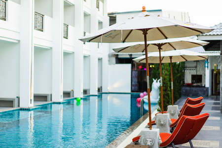 Chair poolside bar in the evening in a luxury hotel in evening time.