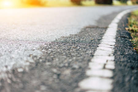 White lines on the road after rain in morning sun.の写真素材