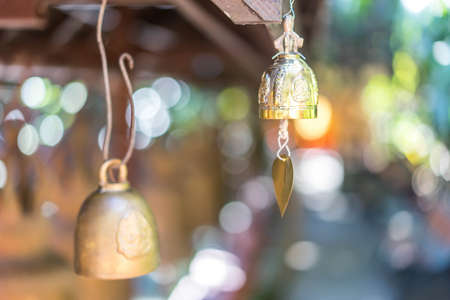 Bell of golden calm in a bright morning temple in THAILAND.の写真素材
