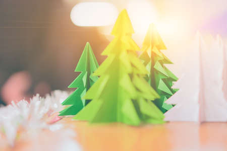 Christmas tree made of bright green paper in the sunlight.の写真素材