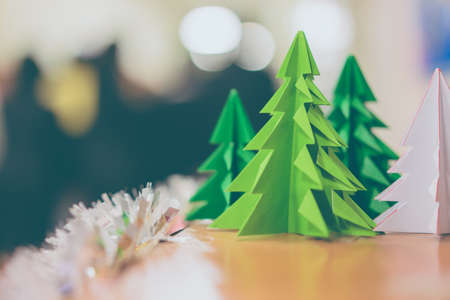 Christmas tree made of bright green paper in the backlight in vintage tone.の写真素材