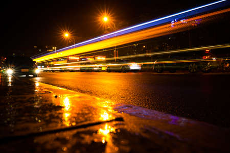 line of light on the street in the city on a rainy day at night.