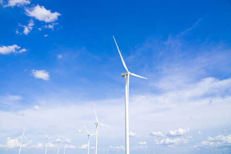 The wind turbines used to generate electricity provide clean energy to the earth on clear days.の写真素材